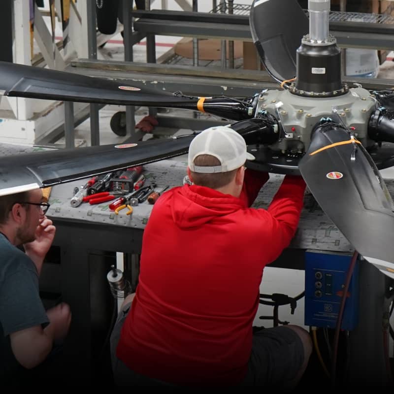 Hartzell technicians work on a large Hartzell propeller