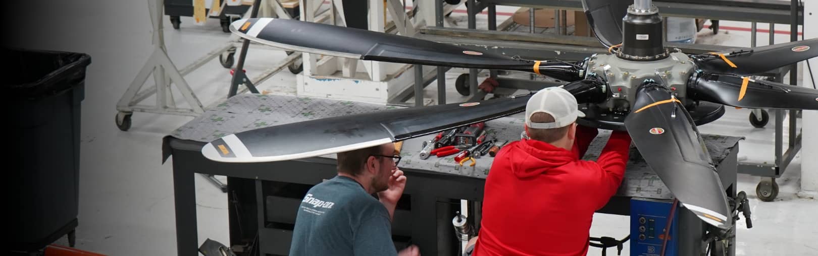 Hartzell technicians work on a large Hartzell propeller