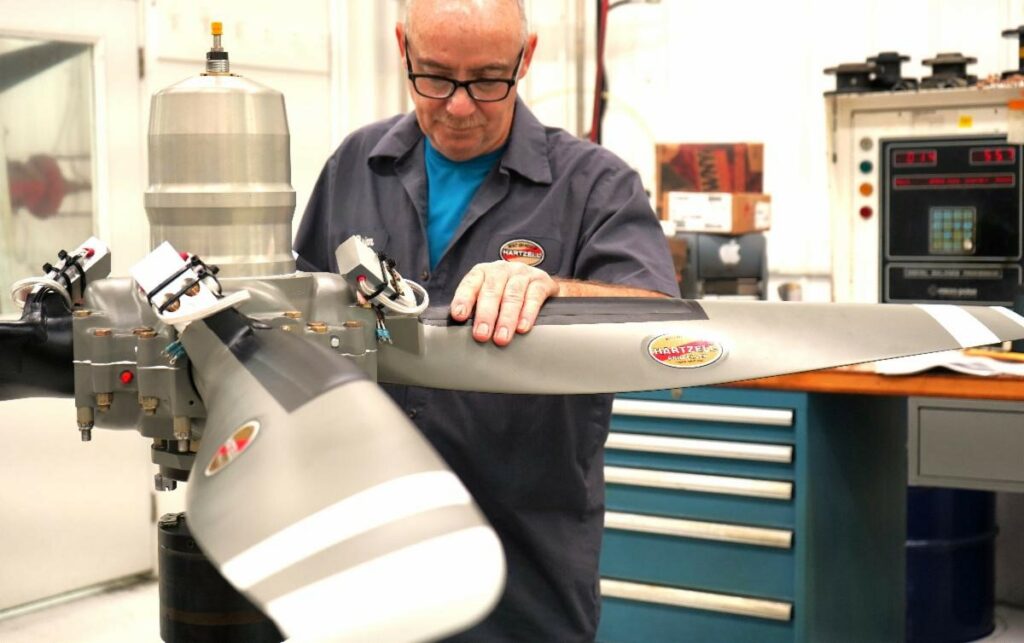 Hartzell technician adjusts propeller on a pedestal